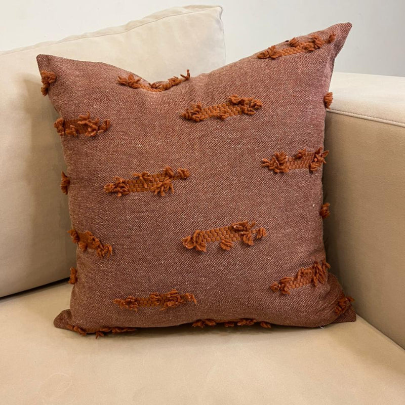 Terracotta textured fringe decorative cushion cover with woven fabric on beige sofa