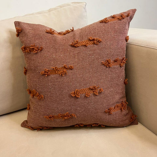 Terracotta textured fringe decorative cushion cover with woven fabric on beige sofa