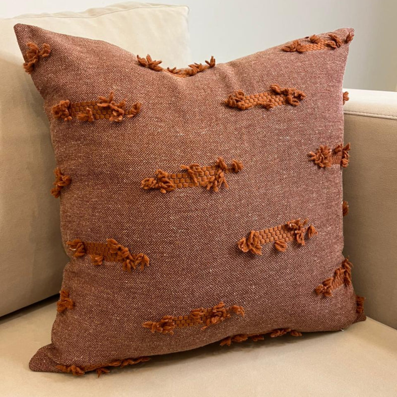 Terracotta textured fringe decorative cushion cover with woven fabric on beige sofa