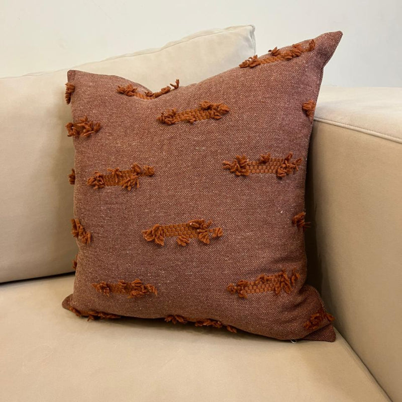 Terracotta textured fringe decorative cushion cover with woven fabric on beige sofa