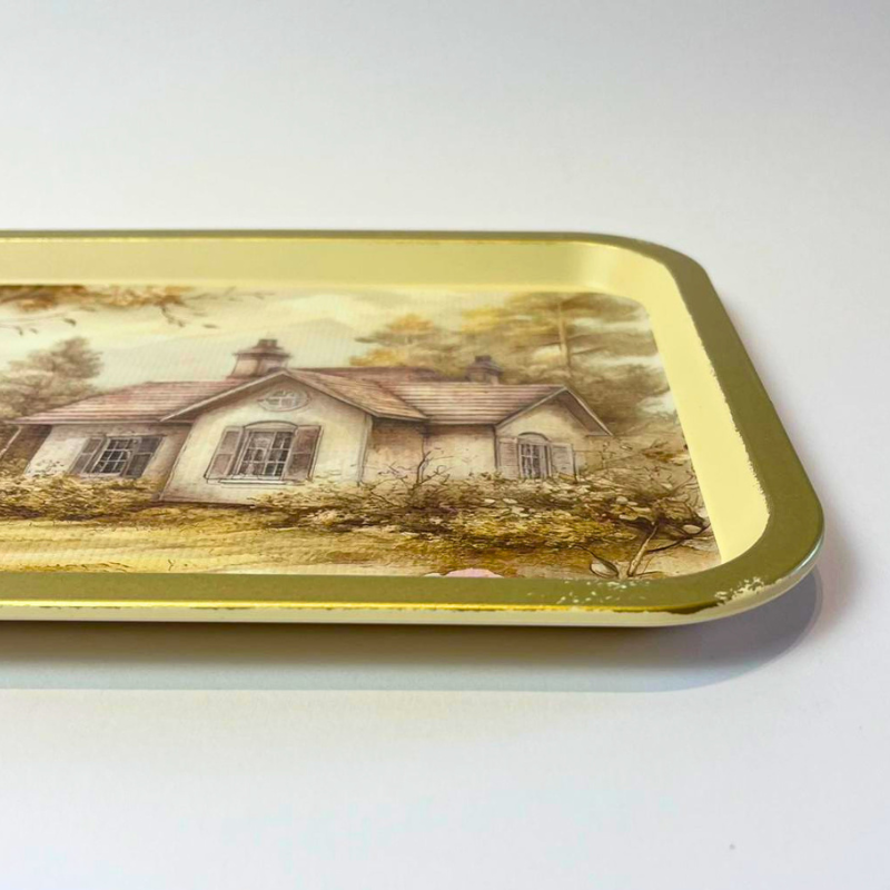 Rectangular serving tray with vintage cottage landscape, floral details, and gold-toned border