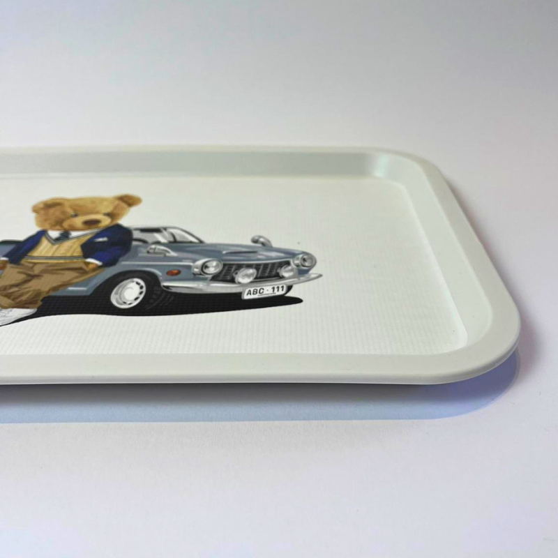 Tray with a teddy bear and car illustration on a white background