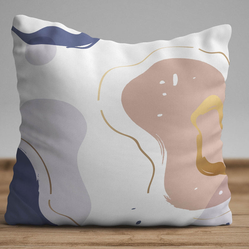 Neutral cushion cover with abstract shapes in beige, blue, and soft gold accents on a modern decorative pillow