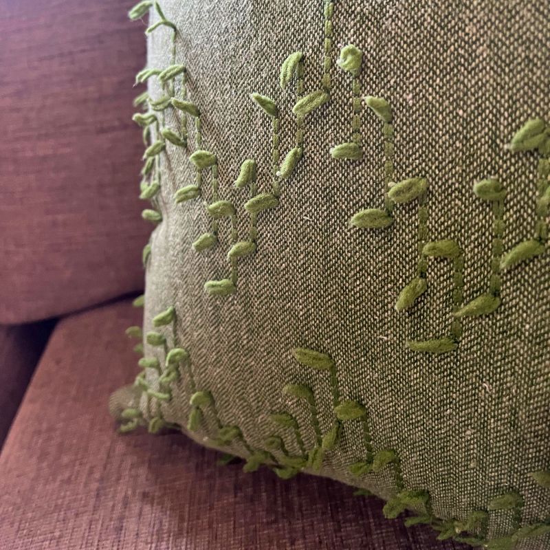 Polka Zigzag Collection – 43x43 cm leafy green embroidered cushion cover on beige sofa