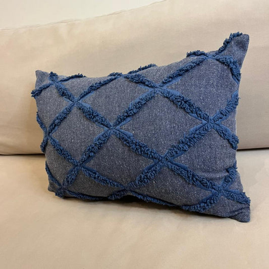 Dusty blue textured decorative cushion cover with raised diamond pattern on beige sofa