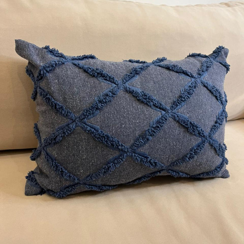 Dusty blue textured decorative cushion cover with raised diamond pattern on beige sofa