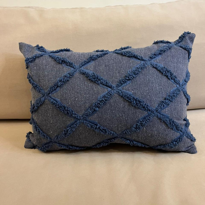 Dusty blue textured decorative cushion cover with raised diamond pattern on beige sofa