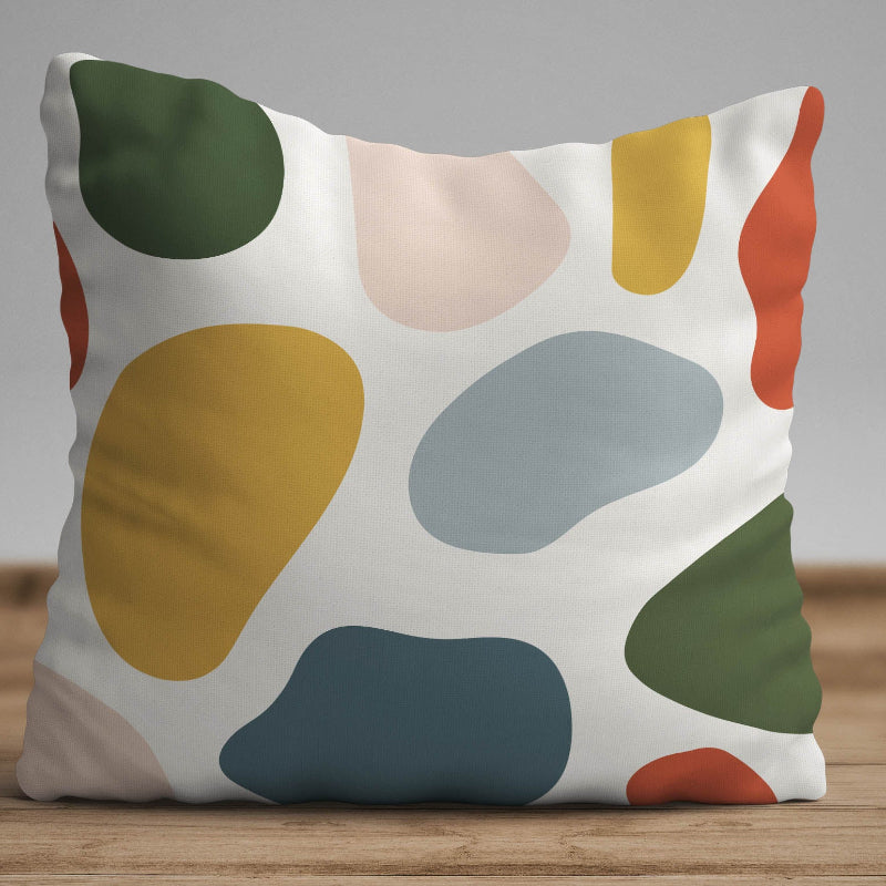 White cushion with black grid lines and abstract colored shapes in a modern geometric design