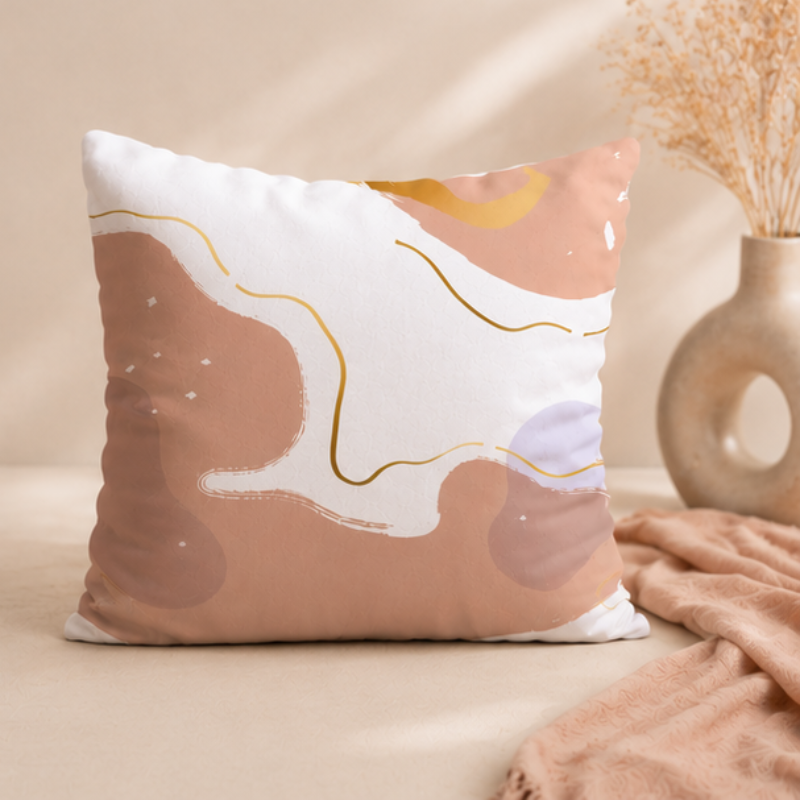 Beige and blush abstract cushion cover with soft flowing organic shapes on a white background