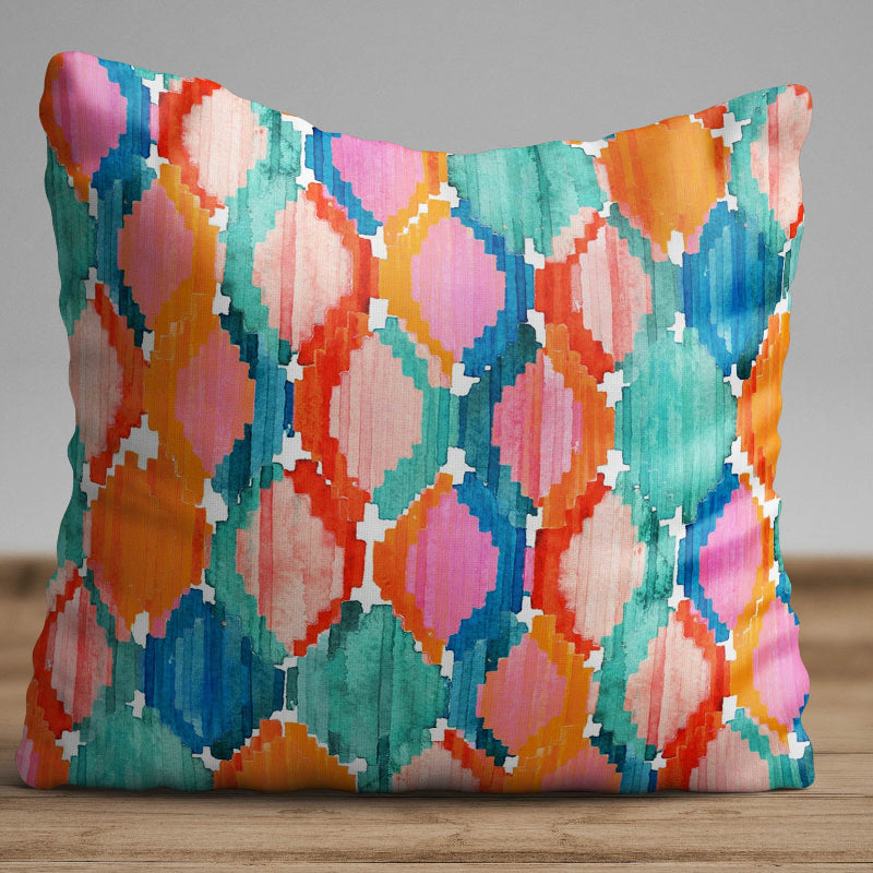 Colorful ikat pattern cushion cover with watercolor geometric design in teal, pink, and orange tones