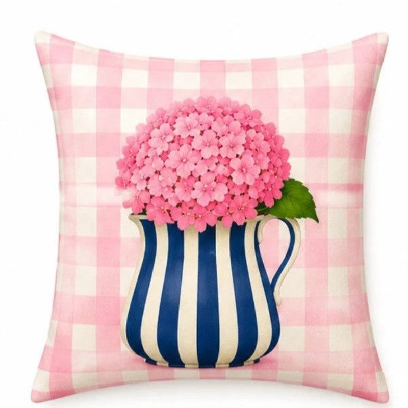 Set of four pastel hydrangea decorative cushion covers featuring floral bouquets, striped ceramic vases, gingham backgrounds, and soft yellow, pink, lavender, and blue accents displayed on a cozy armchair.