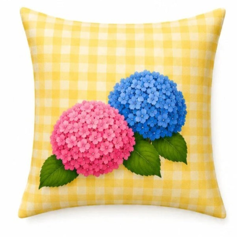 Set of four pastel hydrangea decorative cushion covers featuring floral bouquets, striped ceramic vases, gingham backgrounds, and soft yellow, pink, lavender, and blue accents displayed on a cozy armchair.