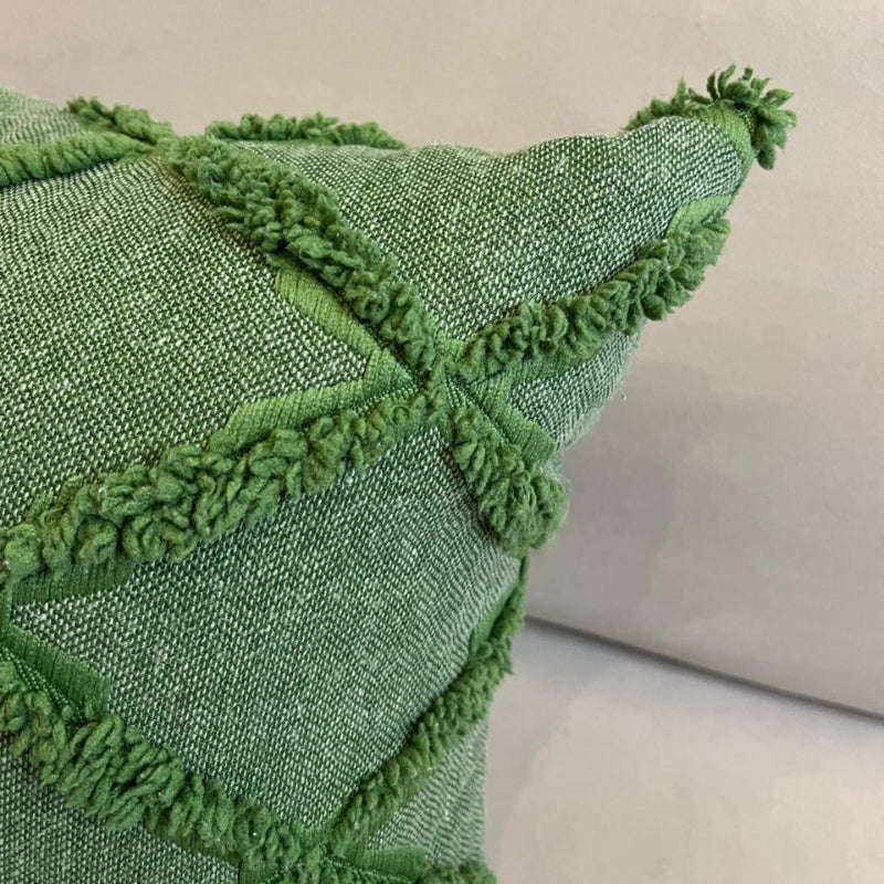 Green textured decorative cushion cover with raised diamond pattern on beige sofa