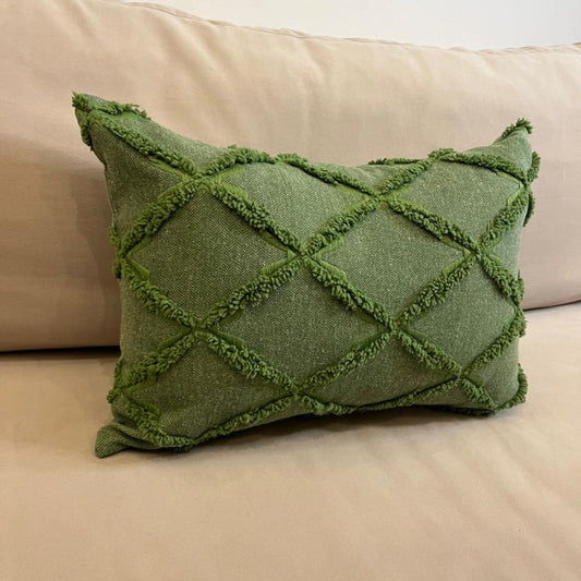 Green textured decorative cushion cover with raised diamond pattern on beige sofa