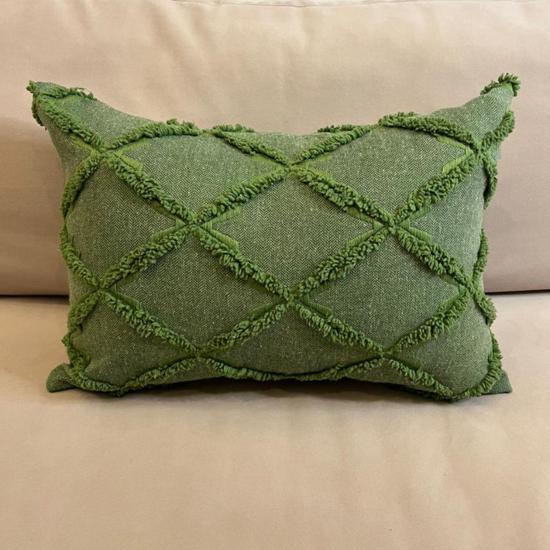 Green textured decorative cushion cover with raised diamond pattern on beige sofa