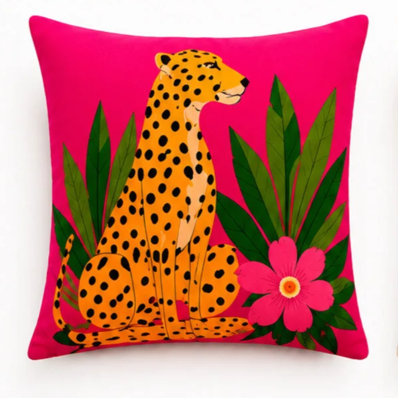 Set of four vibrant tropical decorative cushion covers featuring a cheetah illustration, abstract coral waves, bold white floral artwork, and a palm tree design displayed on a modern white sofa in a lush garden setting.