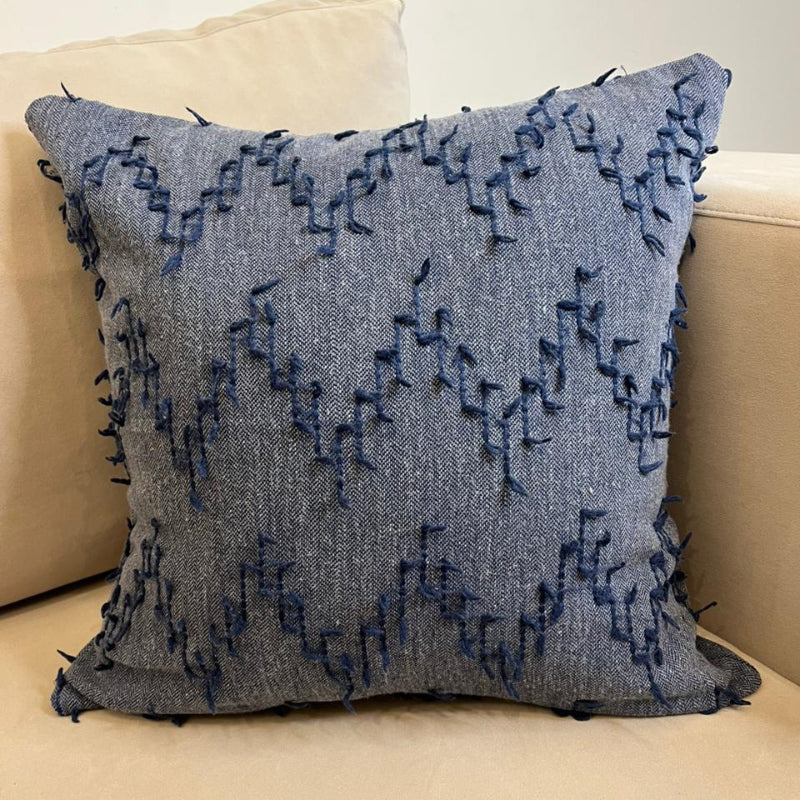 Dusty blue textured fringe decorative cushion cover with woven fabric on beige sofa