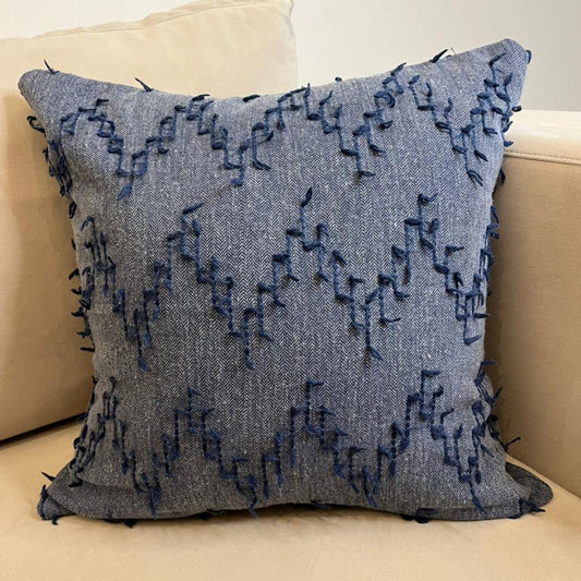 Dusty blue textured fringe decorative cushion cover with woven fabric on beige sofa