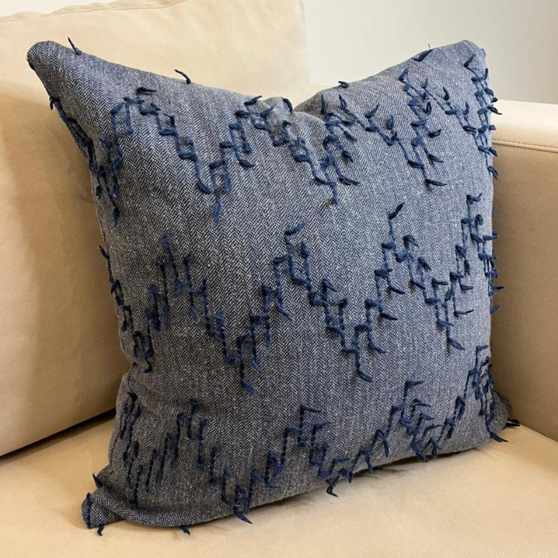 Dusty blue textured fringe decorative cushion cover with woven fabric on beige sofa