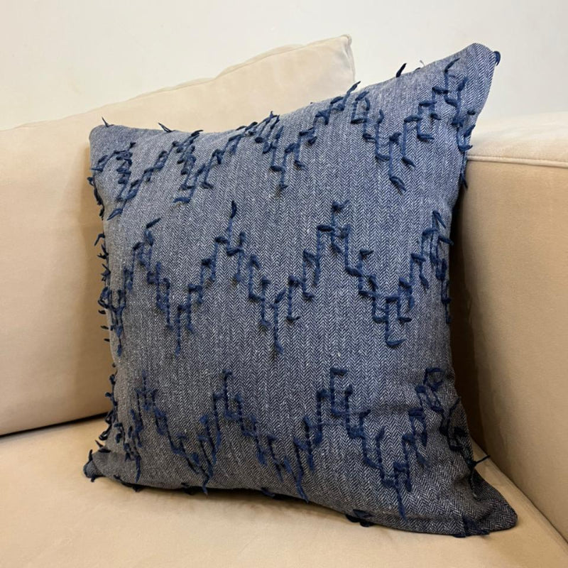 Dusty blue textured fringe decorative cushion cover with woven fabric on beige sofa