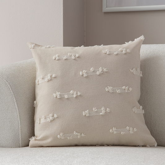 Beige textured woven throw pillow on light sofa – decorative cushion with woven tufted details