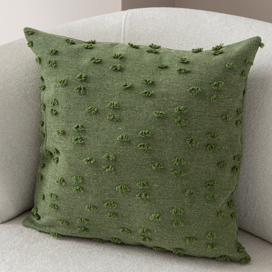 Olive green tufted throw pillow on light sofa – textured decorative cushion