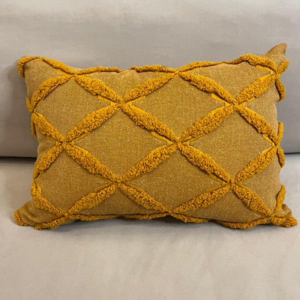 Burnt orange textured decorative cushion cover with raised diamond pattern on beige sofa