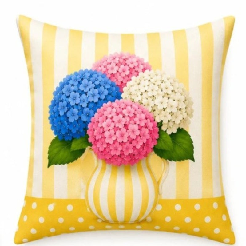 Set of four pastel hydrangea decorative cushion covers featuring floral bouquets, striped ceramic vases, gingham backgrounds, and soft yellow, pink, lavender, and blue accents displayed on a cozy armchair.