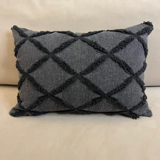 Charcoal gray textured decorative cushion cover with raised diamond pattern on beige sofa