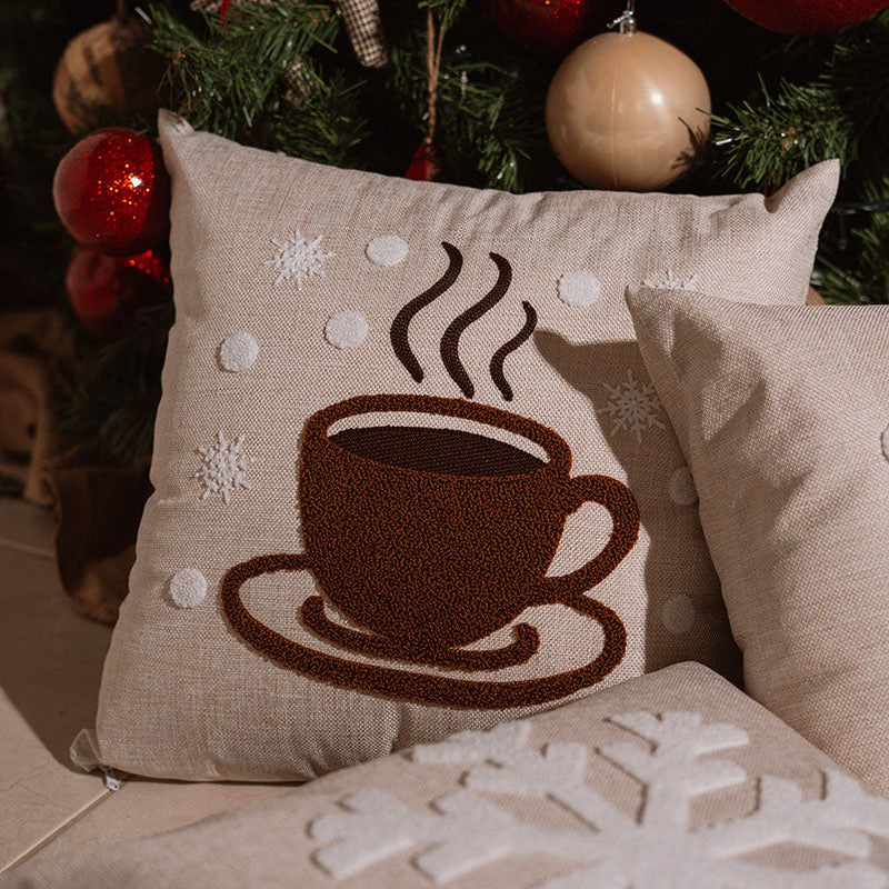 Beige cushion with brown embroidered steaming coffee cup on a blue sofa – Autumn Bloom Collection