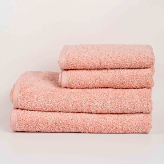 Absorbent blush pink cotton towel folded neatly.