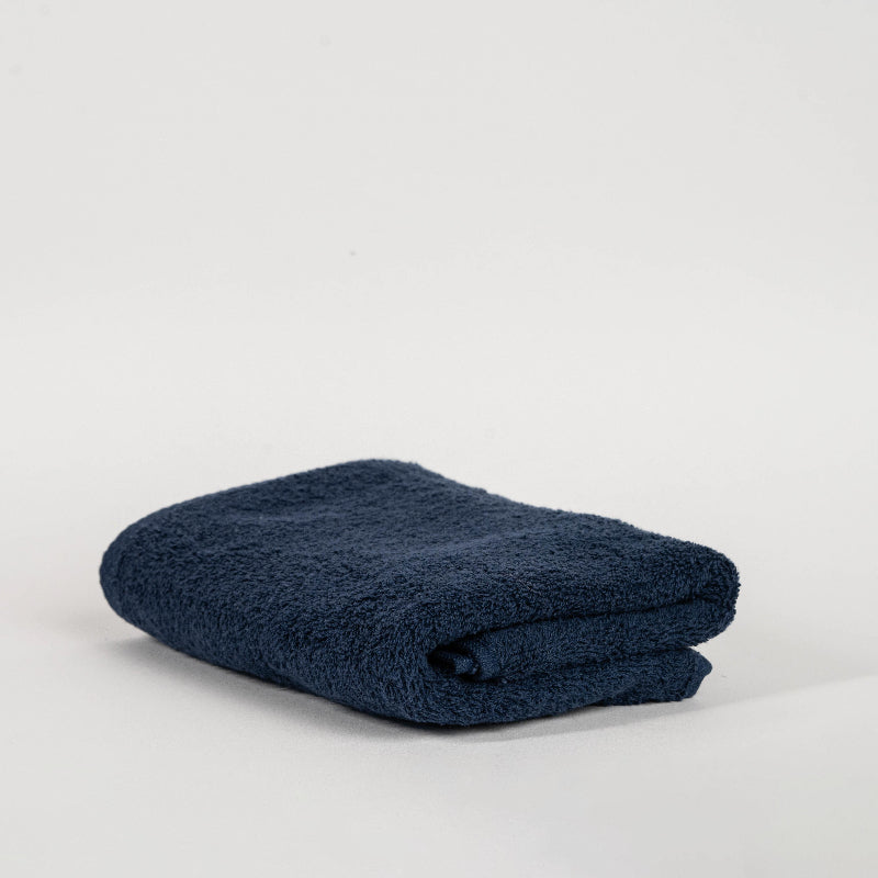 Absorbent midnight blue cotton towel folded neatly.