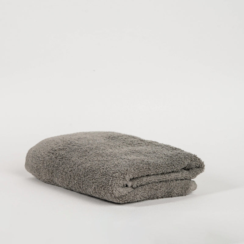 Absorbent stone grey cotton towel folded neatly.