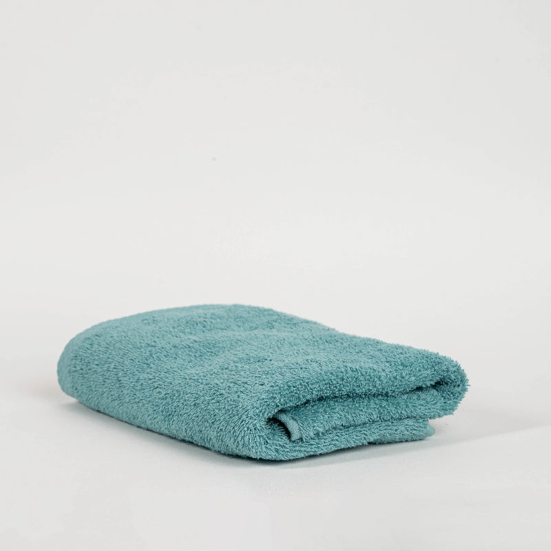 Absorbent pastel green cotton towel folded neatly.