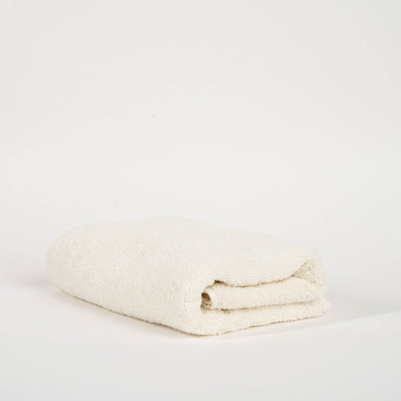 Absorbent cream cotton towel folded neatly.