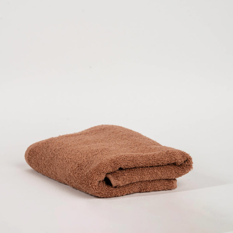 Absorbent mocca cotton towel folded neatly.