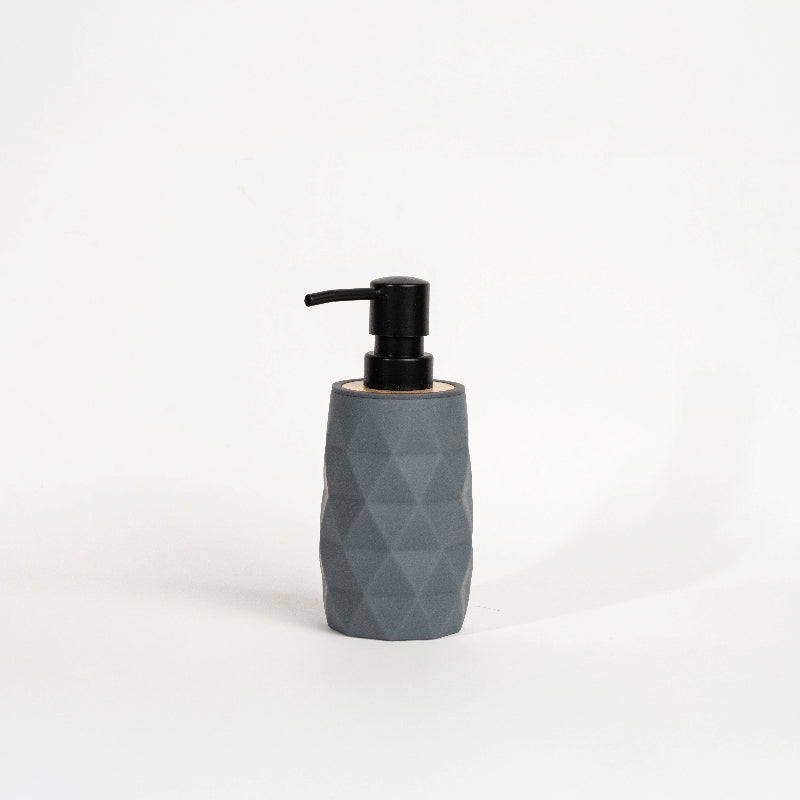 Set of four geometric soap dispensers in gray, white, beige, and black with bamboo detail