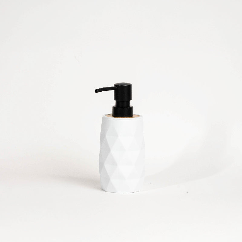 Set of four geometric soap dispensers in gray, white, beige, and black with bamboo detail