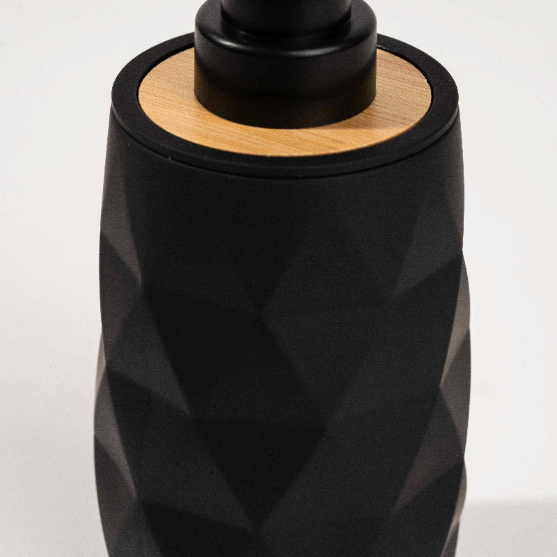 Set of four geometric soap dispensers in gray, white, beige, and black with bamboo detail