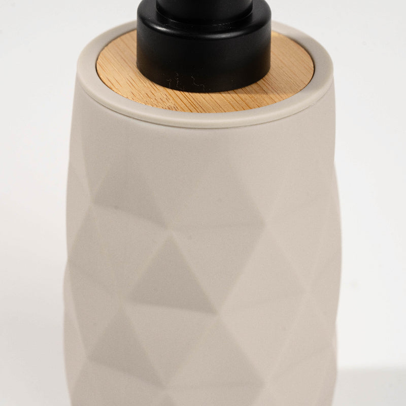 Set of four geometric soap dispensers in gray, white, beige, and black with bamboo detail