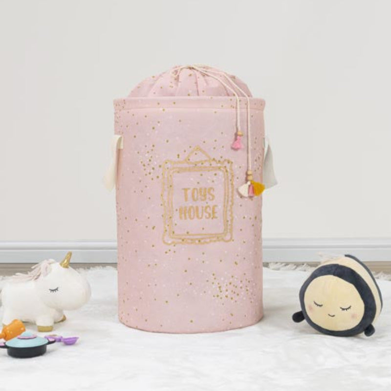 Pink toy storage bin with 'Tous House' branding on a light wooden floor.