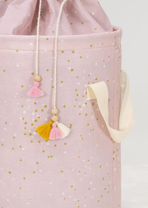 Pink tote bag with gold polka dots and colorful tassels on a white background