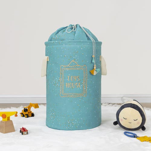 Blue laundry basket with 'Home House' text on a white floor with toys around