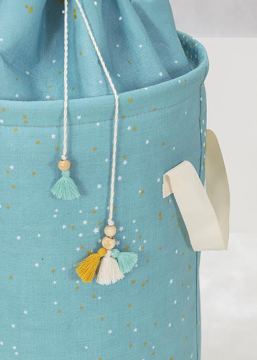 Blue bag with tassel details on a white background