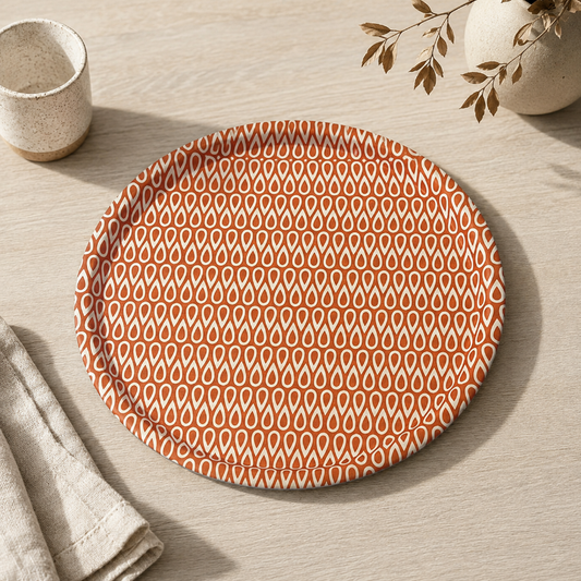Round plate with a red and white pattern on a light gray background