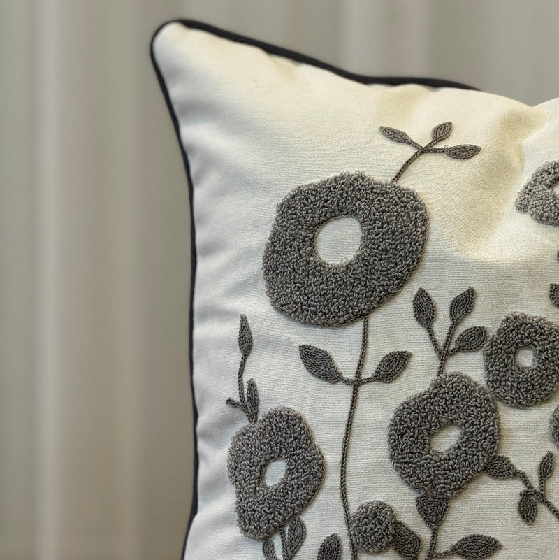 Cream square cushion cover with grey tufted floral embroidery and dark trim
