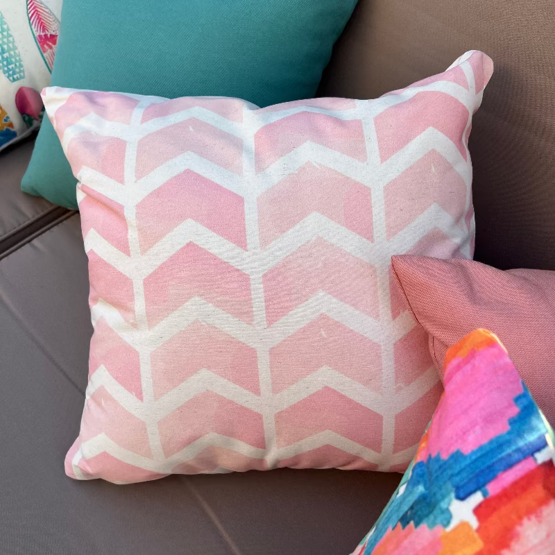 Soft pink geometric chevron cushion cover with minimalist pattern on decorative pillow