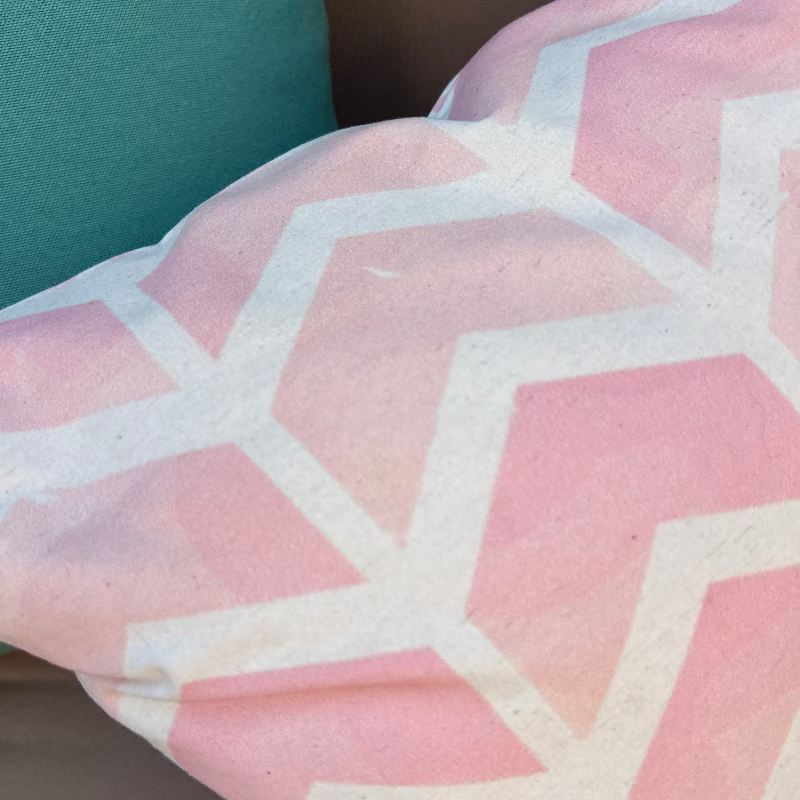 Soft pink geometric chevron cushion cover with minimalist pattern on decorative pillow