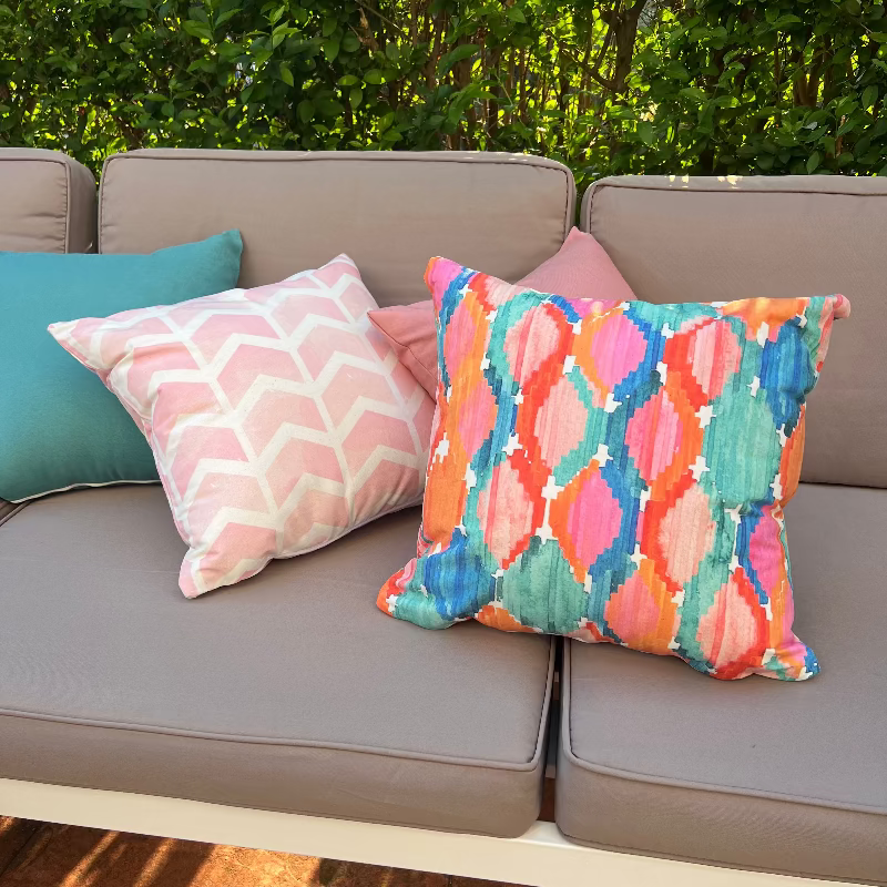 Soft pink geometric chevron cushion cover with minimalist pattern on decorative pillow