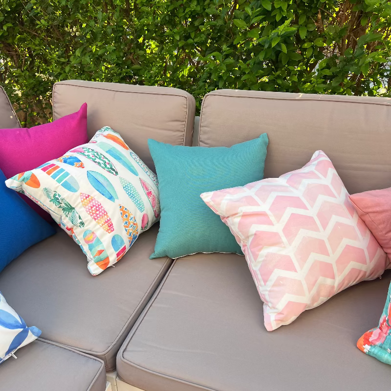 Colorful surfboard pattern cushion cover with tropical pastel designs on decorative pillow